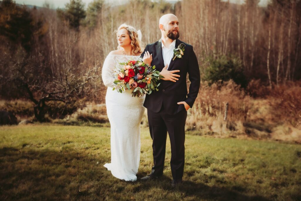 A bride and groom pose for elegant portraits at their intimate wedding in Maine.