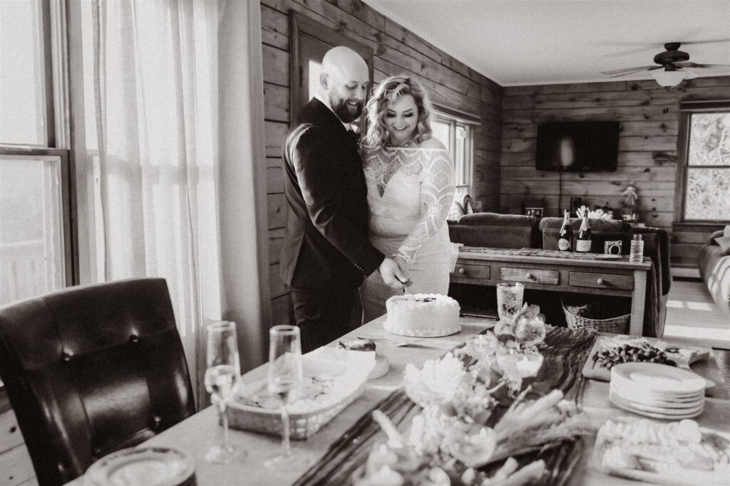 A bride and groom cutting their cake together at their intimate wedding in Maine