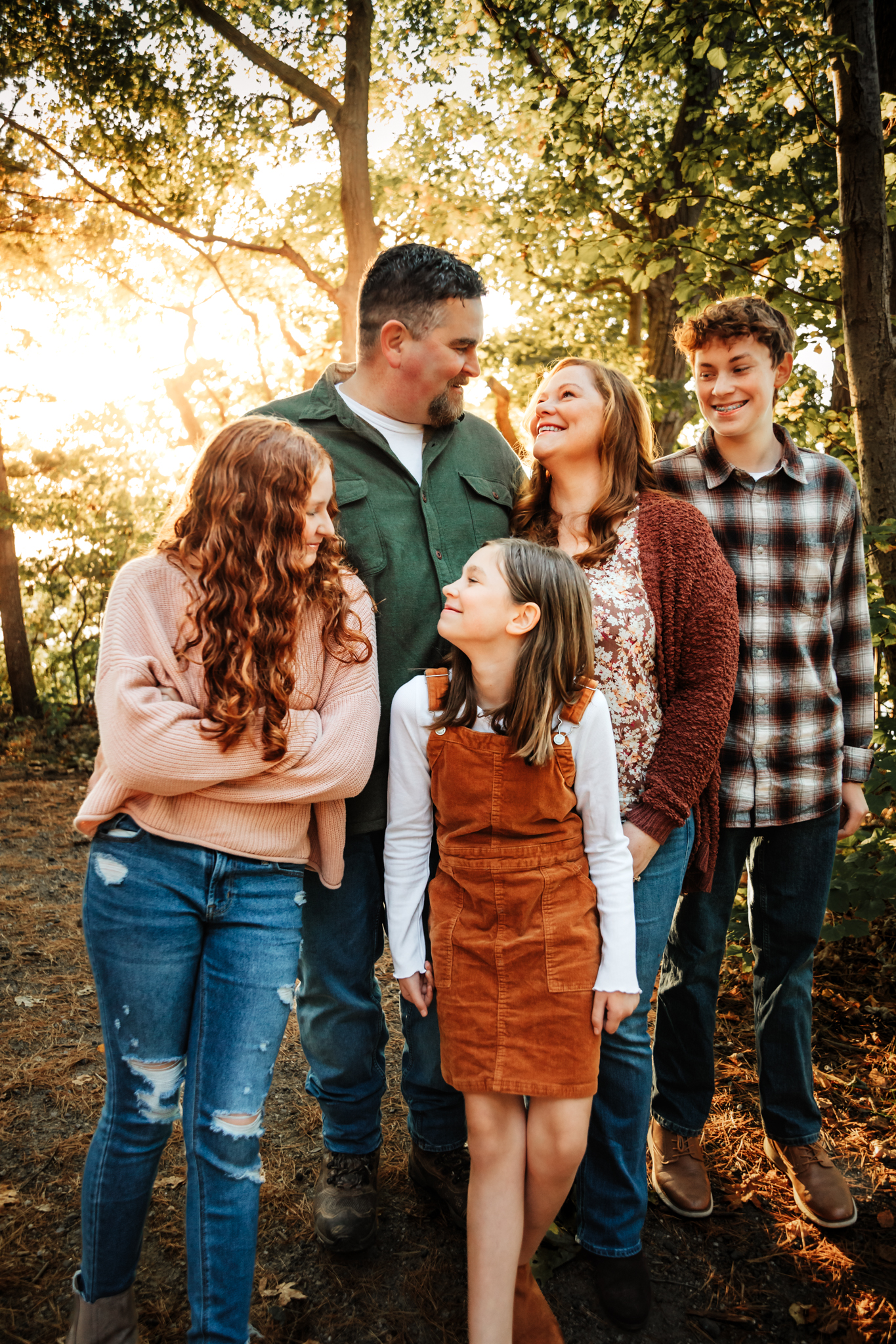 A family at Mackworth Island bathed in golden light laughing with each other