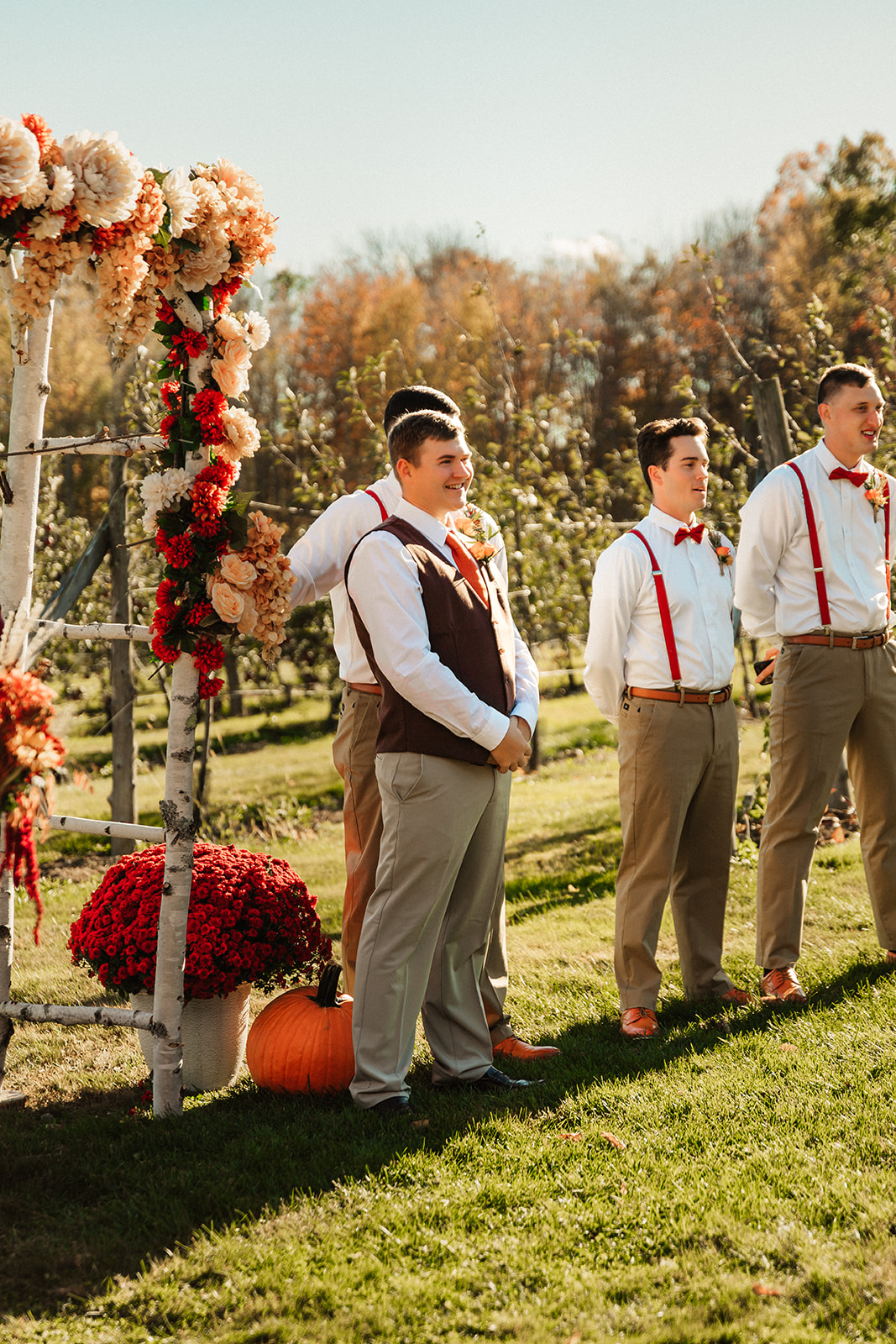 A groom smiles as his bride progresses down the aisle
