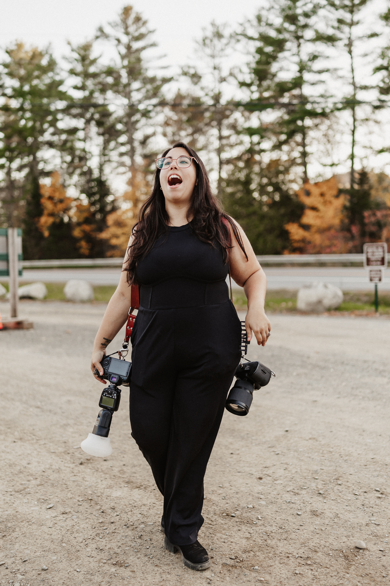 A wedding photographer walking with their gear